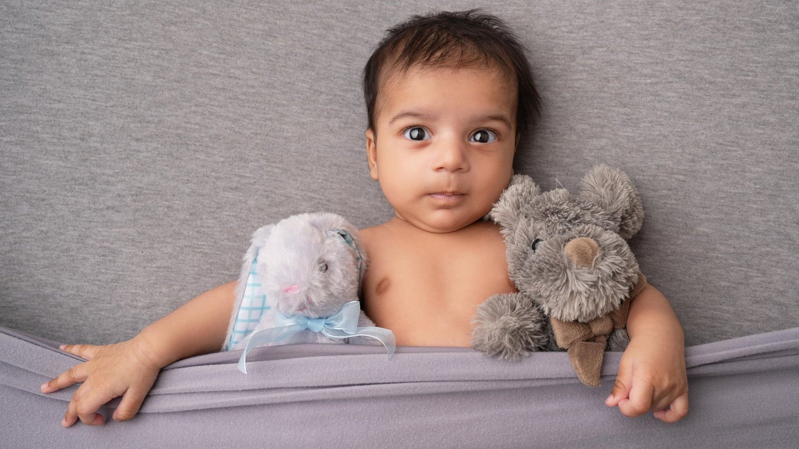 A styled baby photo session with props and a blanket, exactly what a passport photo must avoid