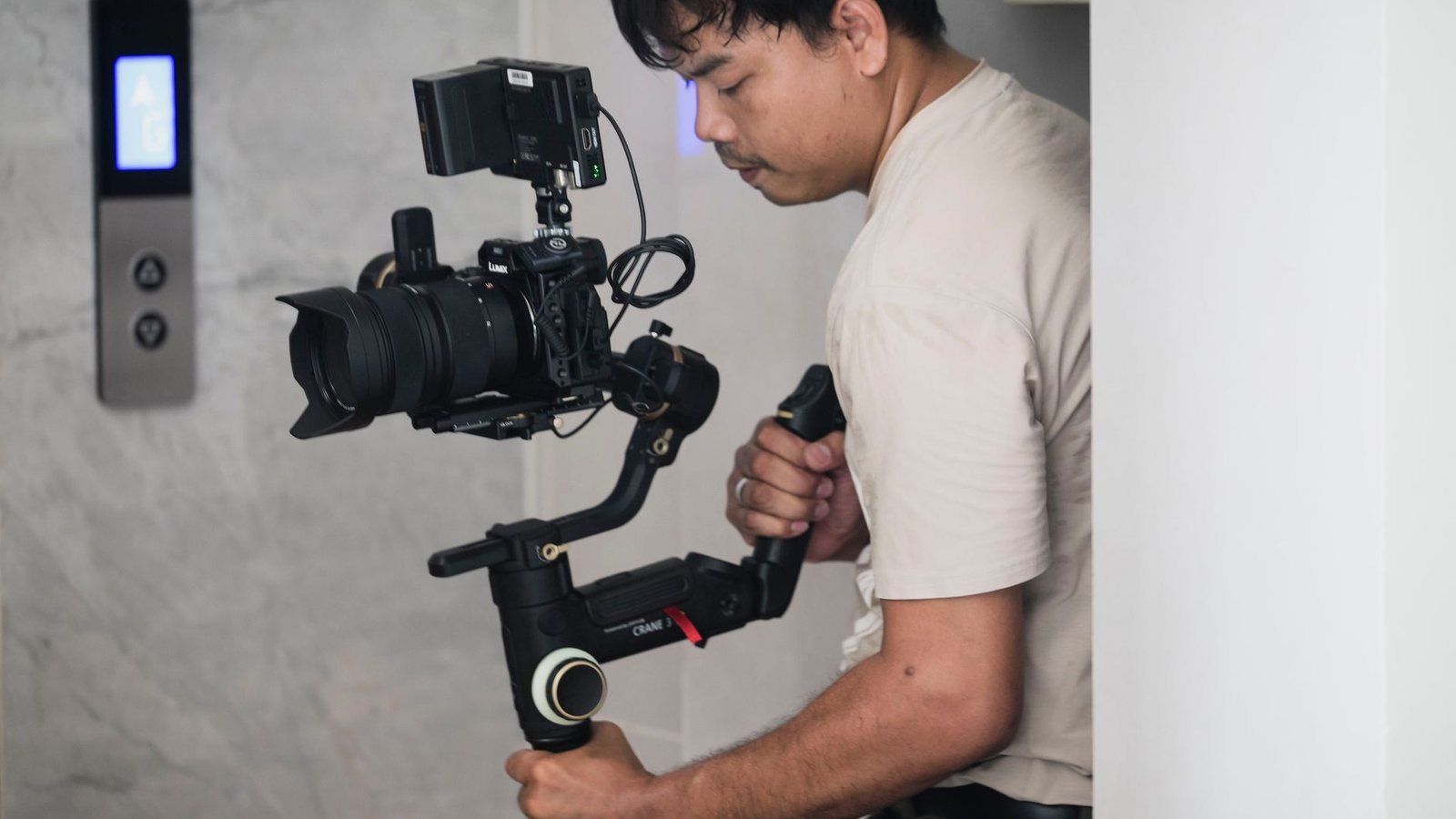 Video creator filming at a bright desk while planning photos for a YouTube thumbnail